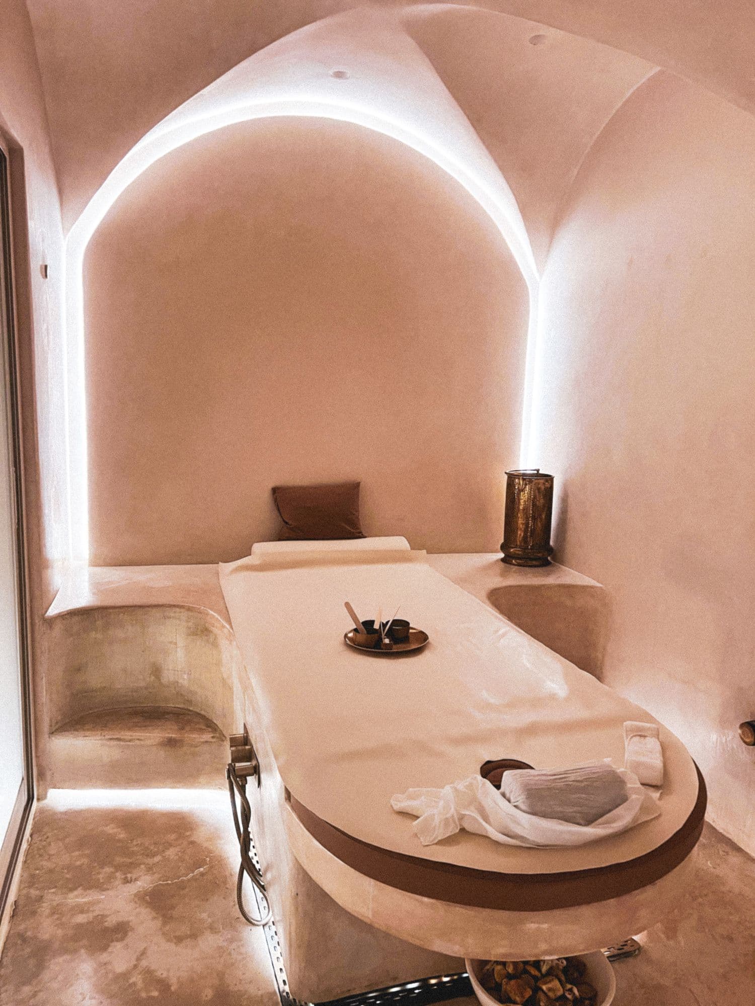 Arched treatment room with warm plaster walls and soft indirect light